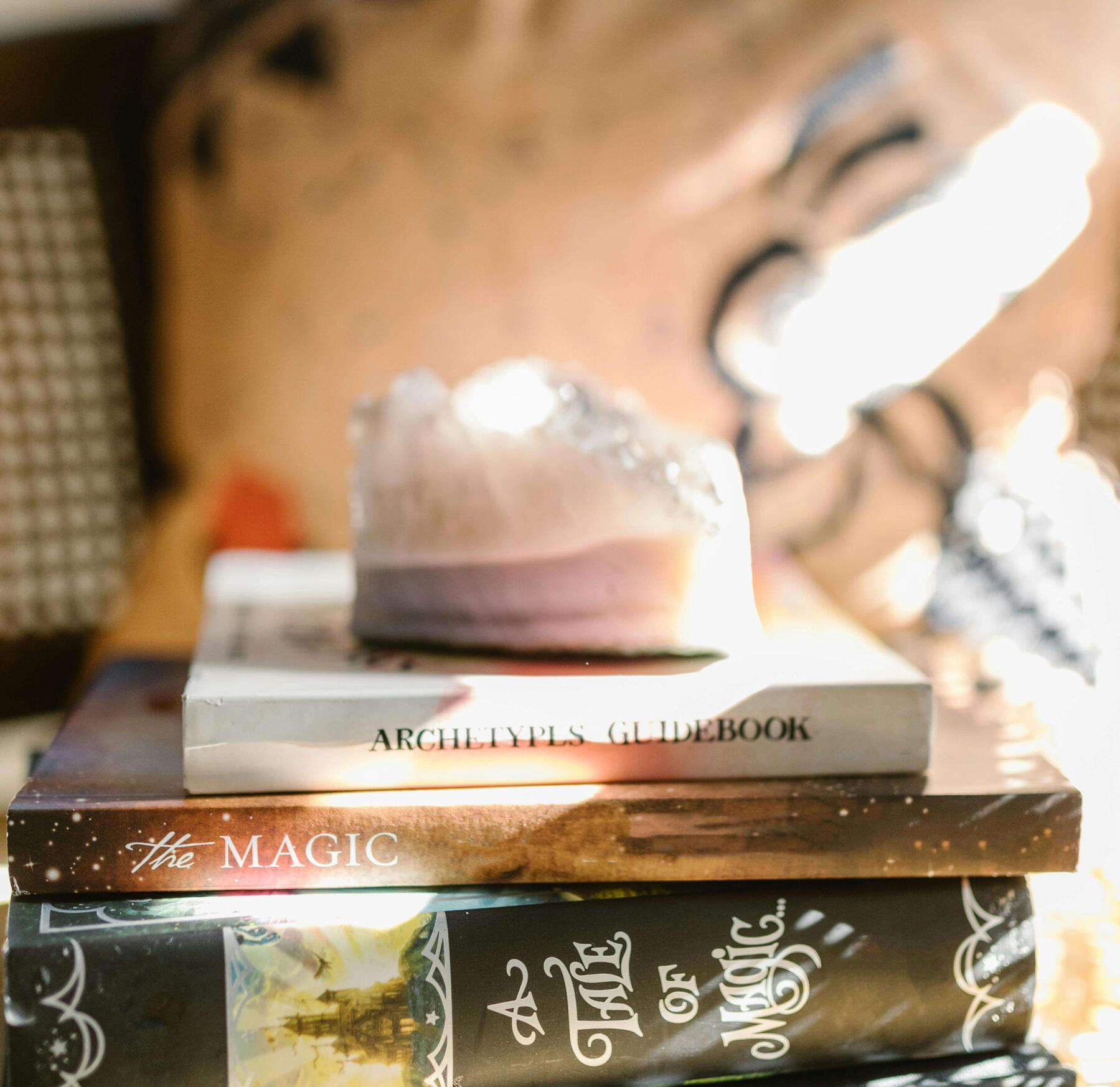 This is a photo of a crystal sitting on top of some magic books